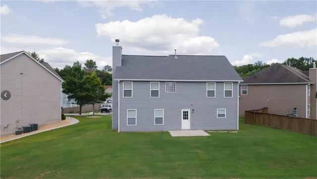 a aerial view of a house next to a yard with potted plants