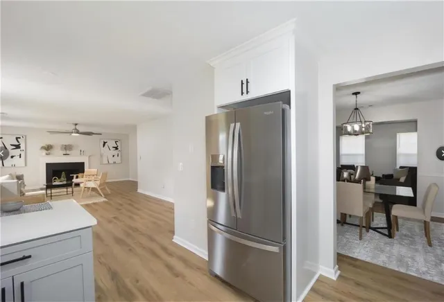a kitchen with stainless steel appliances a refrigerator and a fireplace
