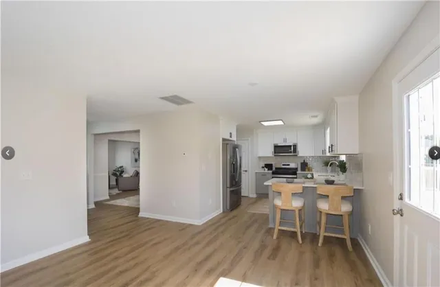 a dining room with furniture and wooden floor