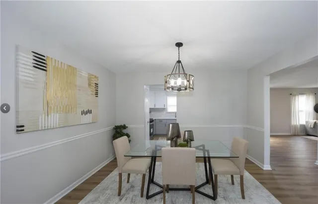 a view of a dining room with furniture wooden floor and chandelier