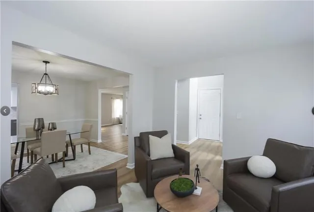 a living room with furniture rug and wooden floor