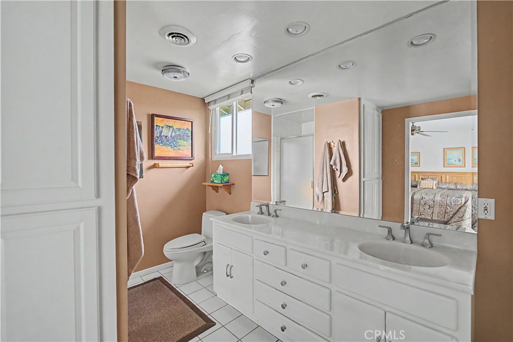 22671 Town Crier Road Calabasas, CA 91302 - Photo 31 of 35 a bathroom with a granite countertop toilet sink and mirror