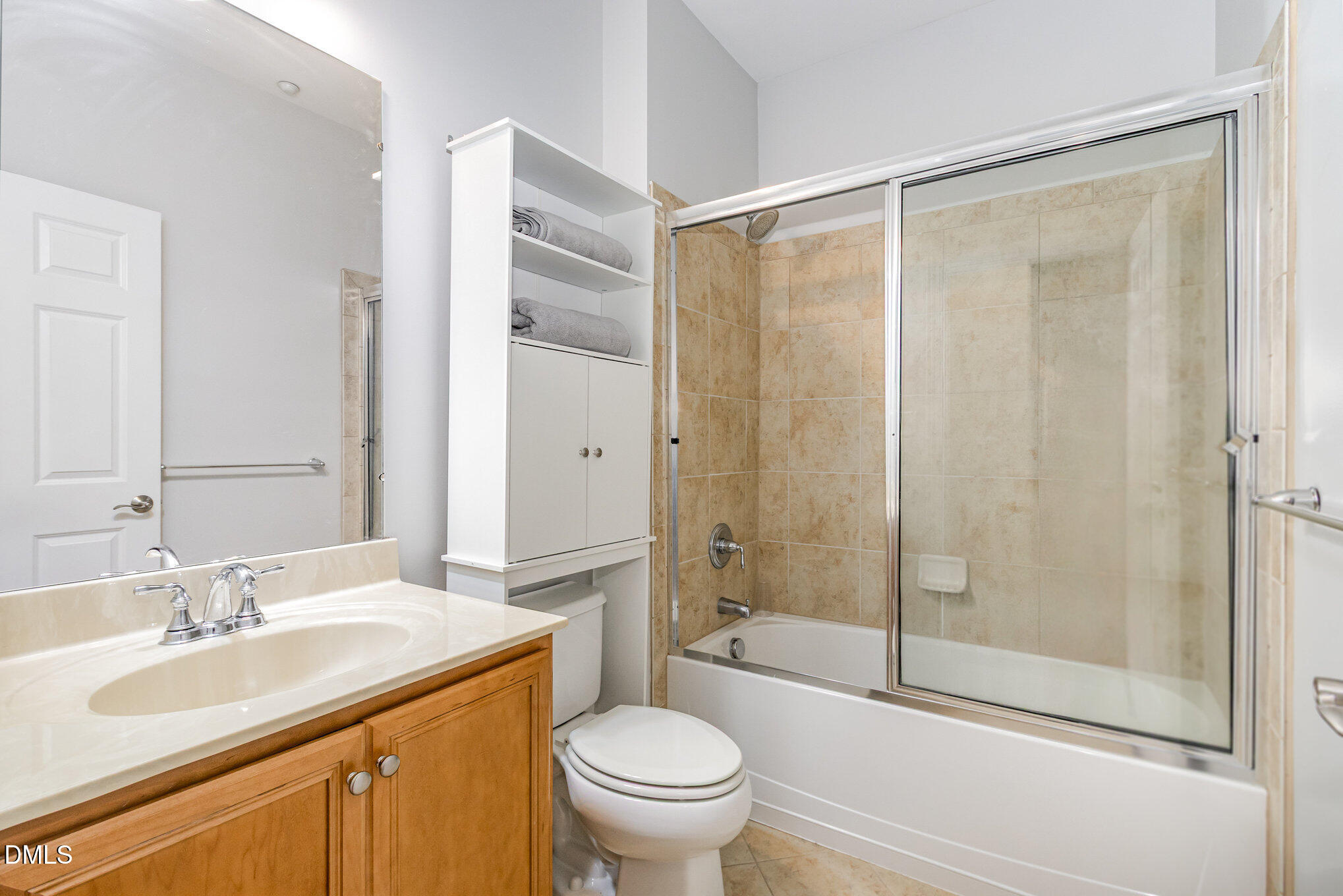 9211 Calabria Drive, Unit 117 Raleigh, NC 27617 - Photo 17 of 19 a bathroom with a granite countertop sink toilet and shower