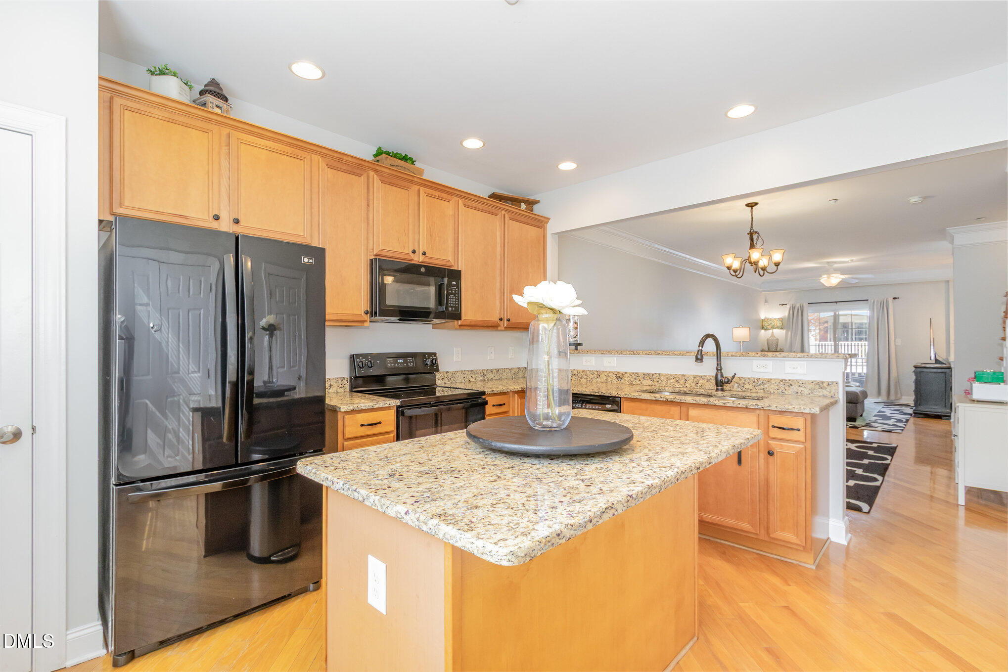 9211 Calabria Drive, Unit 117 Raleigh, NC 27617 - Photo 4 of 19 a kitchen with a refrigerator a sink and a stove