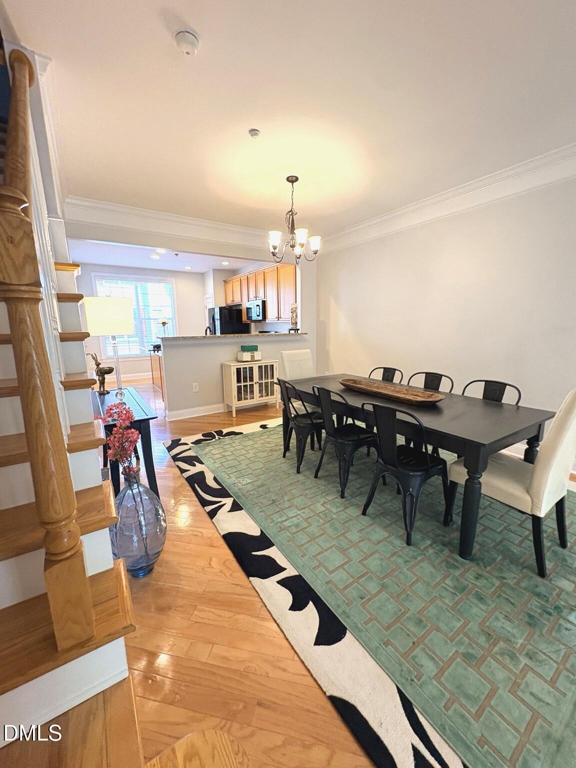 9211 Calabria Drive, Unit 117 Raleigh, NC 27617 - Photo 7 of 19 a living room with lots of furniture and a chandelier