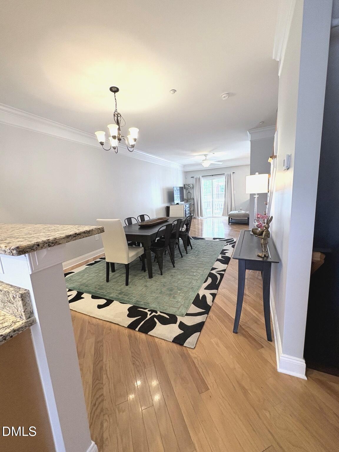 9211 Calabria Drive, Unit 117 Raleigh, NC 27617 - Photo 9 of 19 a living room with furniture and a chandelier