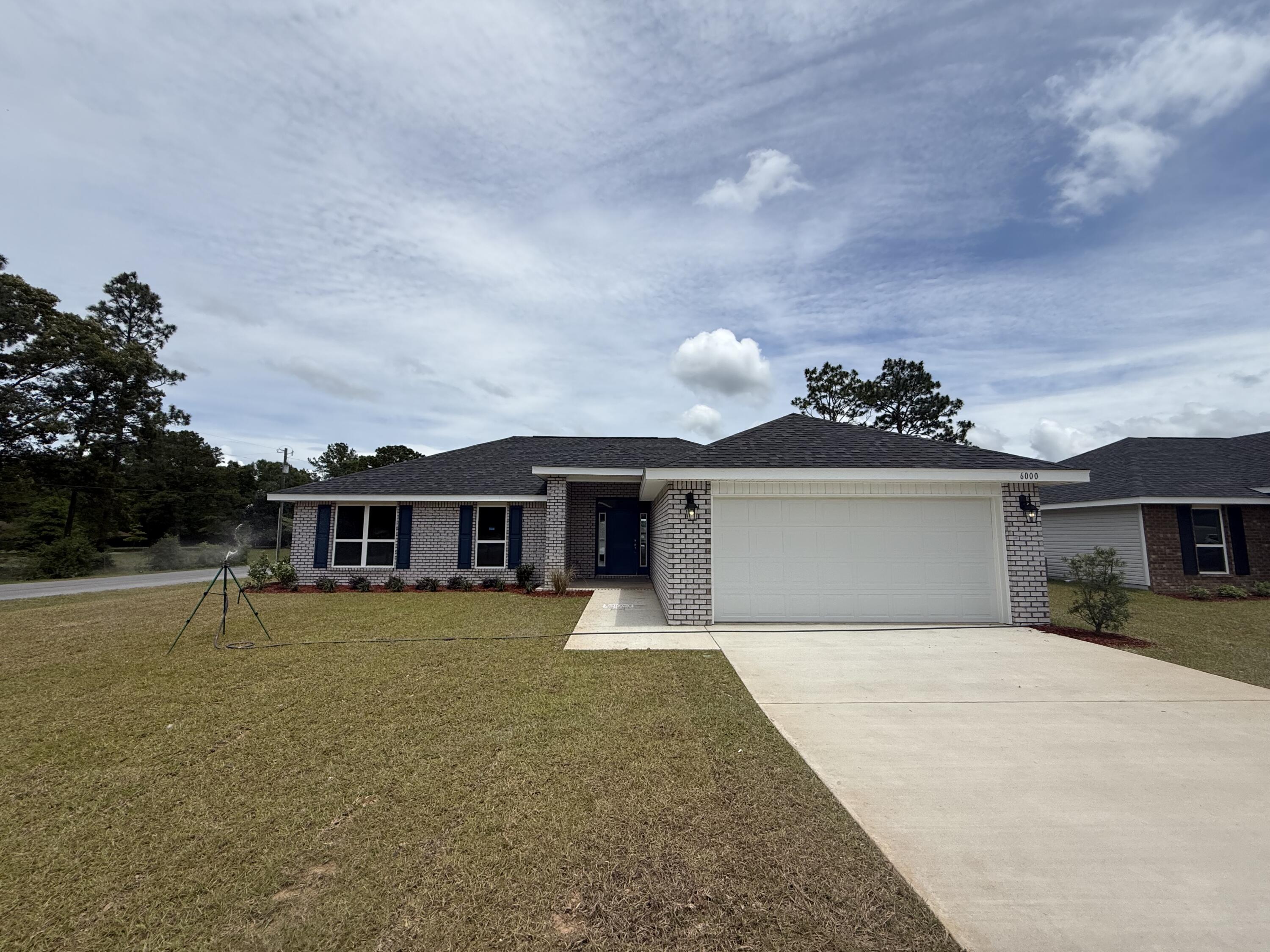 6000 Crocket Cove Crestview, FL 32539 - Photo 1 of 20 a front view of a house with a yard and garage