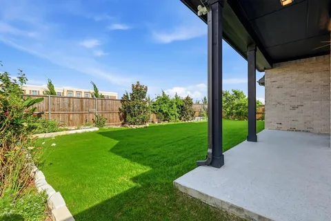 a view of a garden with a building in the background