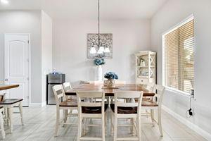 25280 Grove Way Madera, CA 93638 - Photo 11 of 32 a view of a dining room with furniture and windows