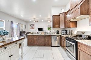 25280 Grove Way Madera, CA 93638 - Photo 16 of 32 a kitchen with kitchen island granite countertop a sink counter top space cabinets and stainless steel appliances