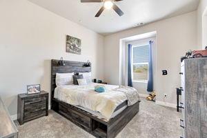 25280 Grove Way Madera, CA 93638 - Photo 20 of 32 a bedroom with a bed and a chandelier