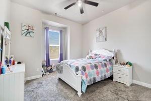 25280 Grove Way Madera, CA 93638 - Photo 22 of 32 a bedroom with a bed and a chandelier