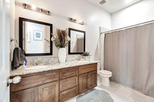 25280 Grove Way Madera, CA 93638 - Photo 23 of 32 a bathroom with double sink and a mirror