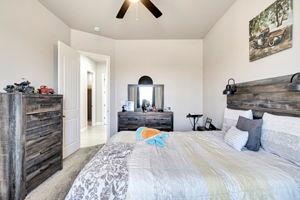 25280 Grove Way Madera, CA 93638 - Photo 24 of 32 a bedroom with a bed and a chandelier