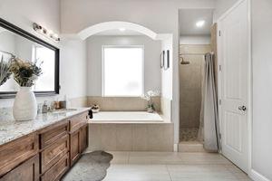 25280 Grove Way Madera, CA 93638 - Photo 26 of 32 a bathroom with a tub a sink and a mirror