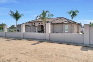 25280 Grove Way Madera, CA 93638 - Photo 32 of 32 a front view of a house with a yard and garage