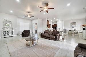 25280 Grove Way Madera, CA 93638 - Photo 7 of 32 a living room with furniture a ceiling fan and a rug