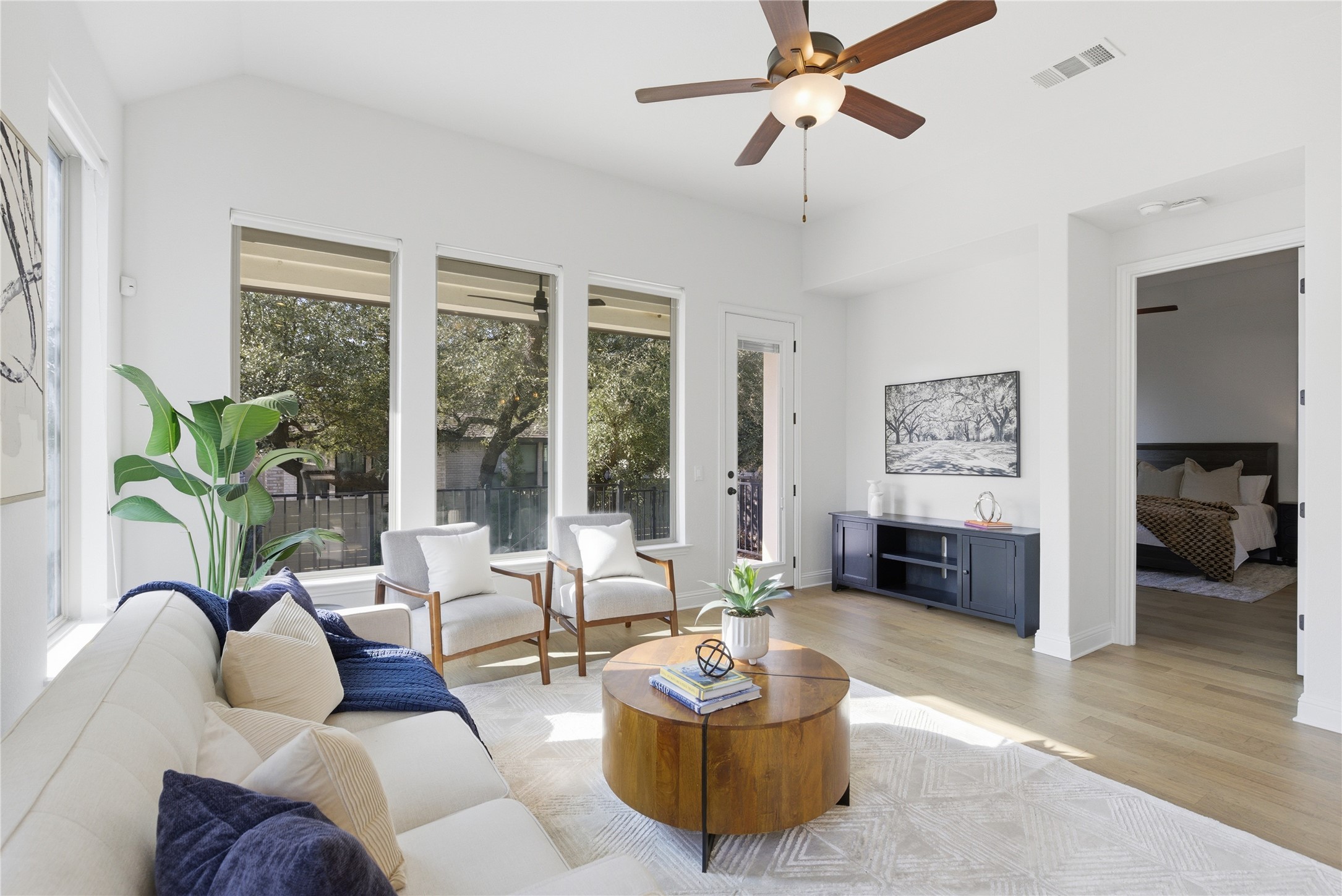 Living room featuring light wood-style flooring and a ceiling fan.