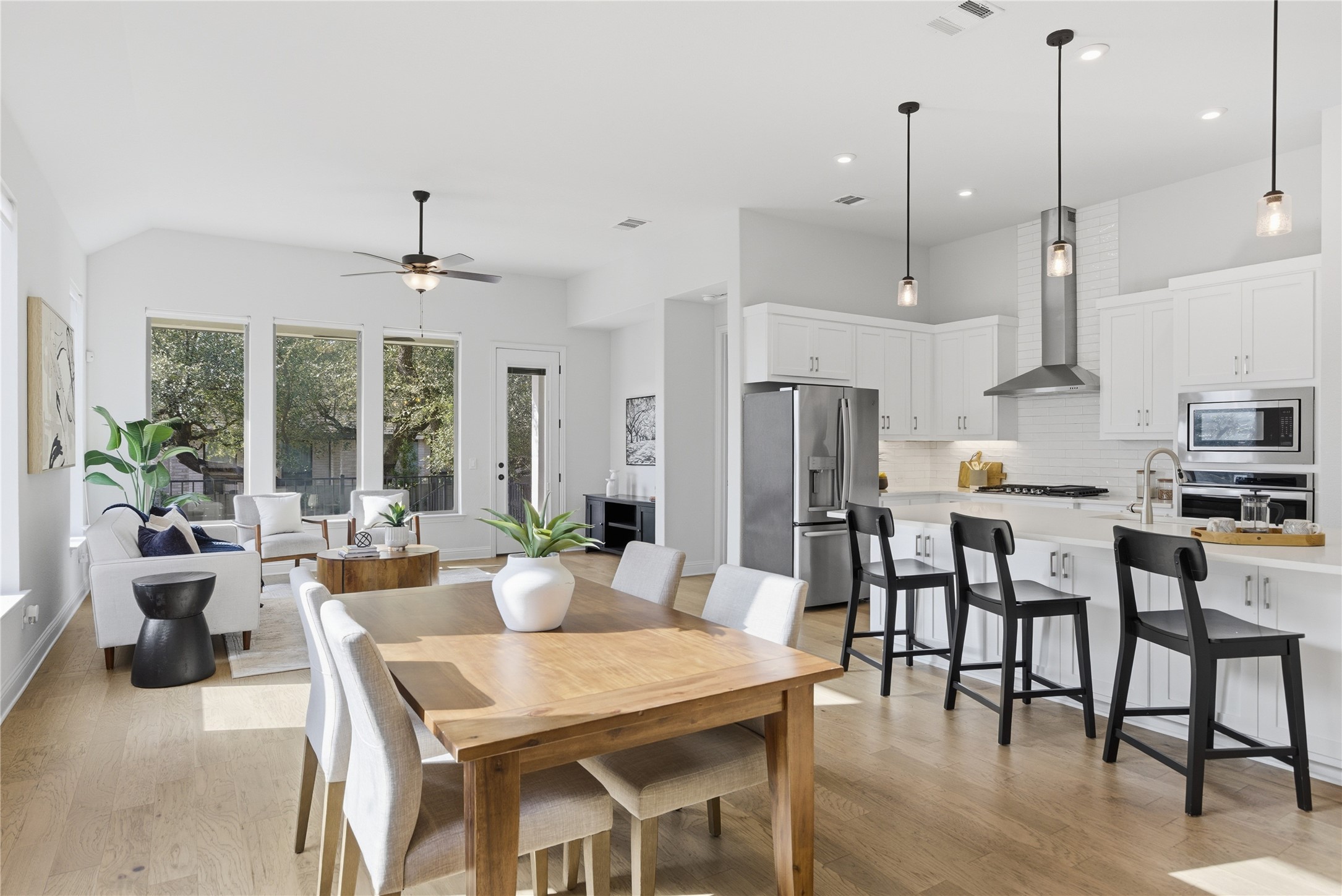 225 Diamondback Drive Georgetown, TX 78628 - Photo 11 of 39 Dining space with light wood-style flooring, vaulted ceiling, and recessed lighting. A wall of windows allow for natural lighting.