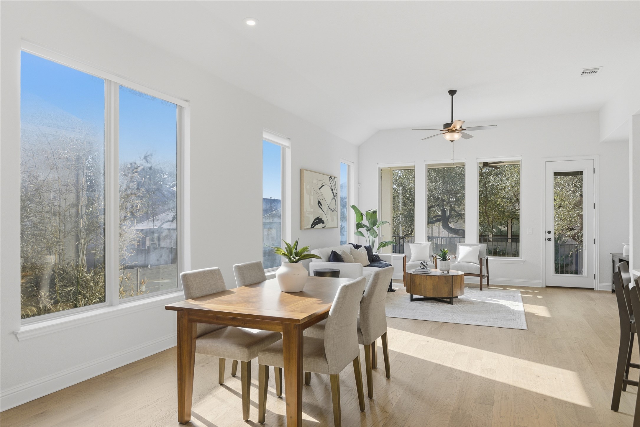 225 Diamondback Drive Georgetown, TX 78628 - Photo 8 of 40 Dining space with light wood-style flooring, vaulted ceiling, and recessed lighting. A wall of windows allow for natural lighting.