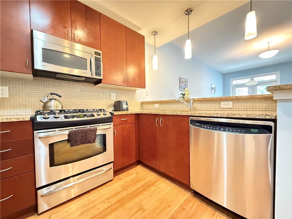 3655 Peachtree Road Northeast, Unit 304 Atlanta, GA 30319 - Photo 12 of 36 a kitchen with stainless steel appliances a stove a microwave and sink