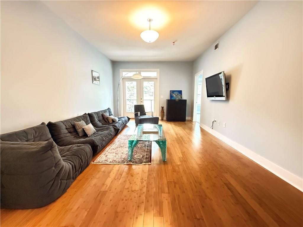 3655 Peachtree Road Northeast, Unit 304 Atlanta, GA 30319 - Photo 14 of 36 a living room with furniture and a flat screen tv