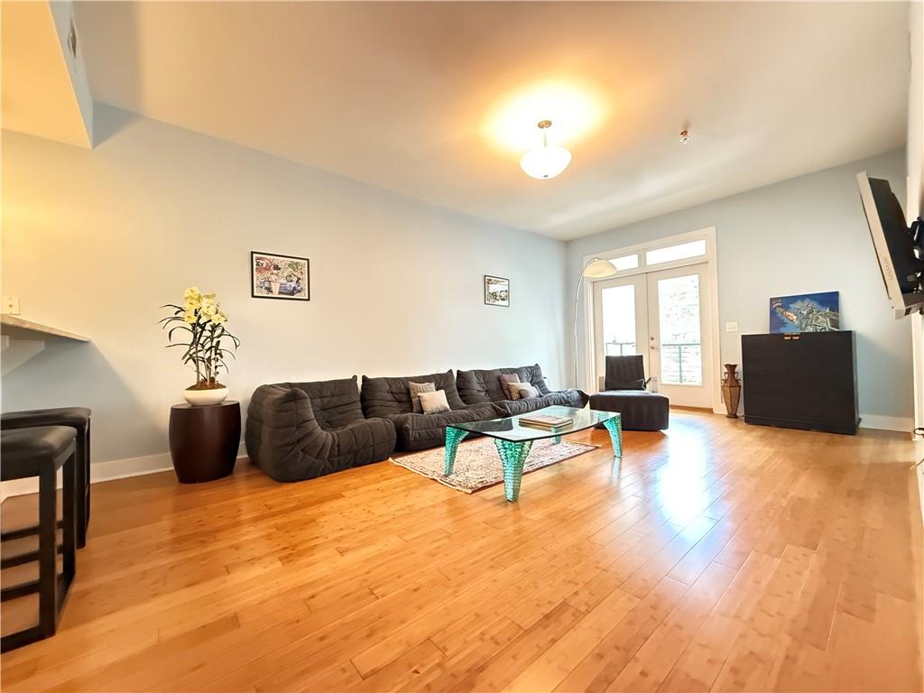 3655 Peachtree Road Northeast, Unit 304 Atlanta, GA 30319 - Photo 15 of 36 a living room with furniture and wooden floor
