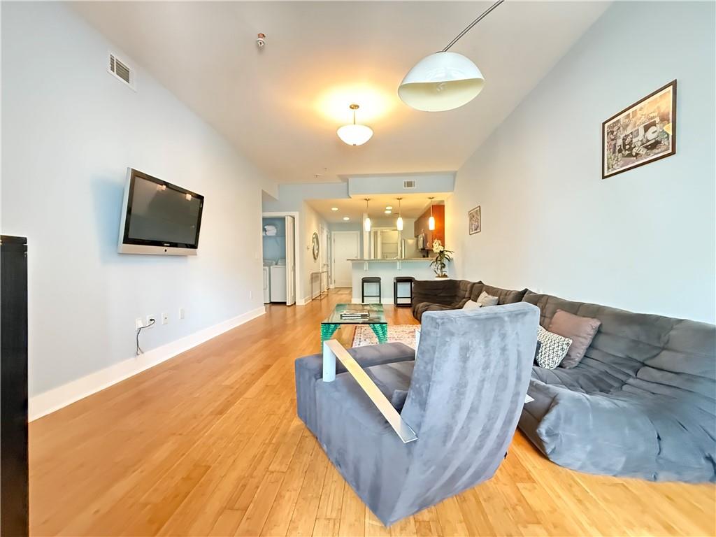 3655 Peachtree Road Northeast, Unit 304 Atlanta, GA 30319 - Photo 17 of 36 a living room with couches and a flat screen tv