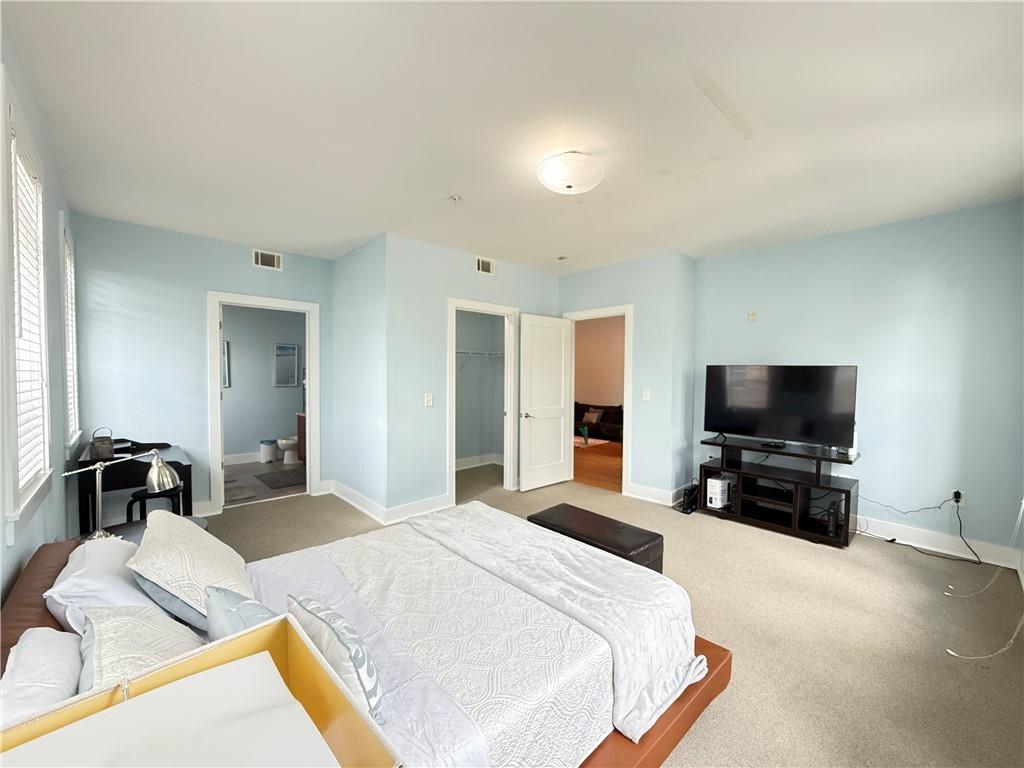 3655 Peachtree Road Northeast, Unit 304 Atlanta, GA 30319 - Photo 19 of 36 a bedroom with a bed and a flat screen tv
