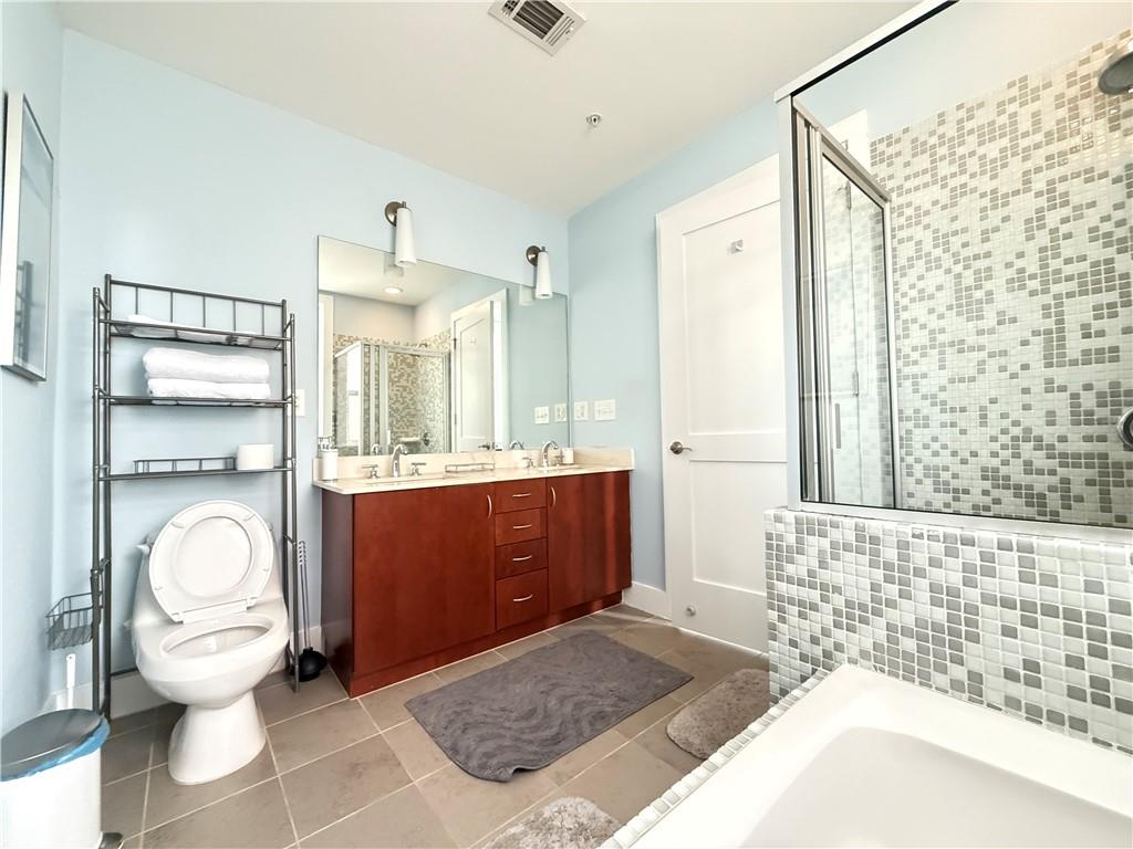 3655 Peachtree Road Northeast, Unit 304 Atlanta, GA 30319 - Photo 24 of 36 a bathroom with a sink a toilet and shower