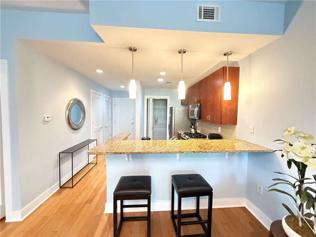 3655 Peachtree Road Northeast, Unit 304 Atlanta, GA 30319 - Photo 10 of 36 a dining room filled chandelier and wooden floor