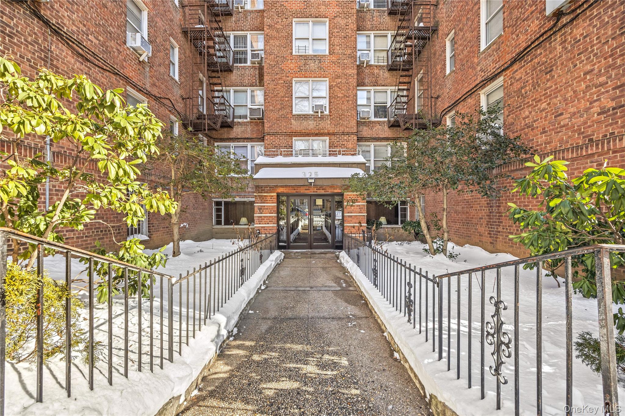 325 East 201st Street, Unit 5F Bronx, NY 10458 - Photo 16 of 19 a view of a brick building from a balcony