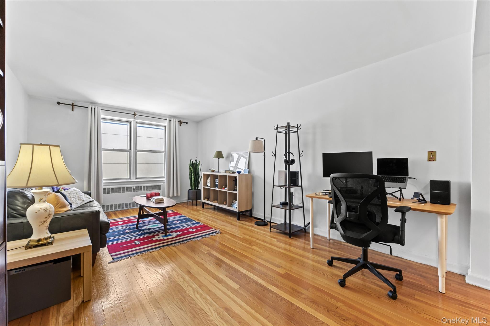 325 East 201st Street, Unit 5F Bronx, NY 10458 - Photo 3 of 19 a living room with furniture and a flat screen tv