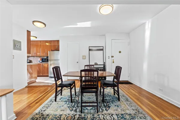 a view of a a dining room with furniture window and wooden floor