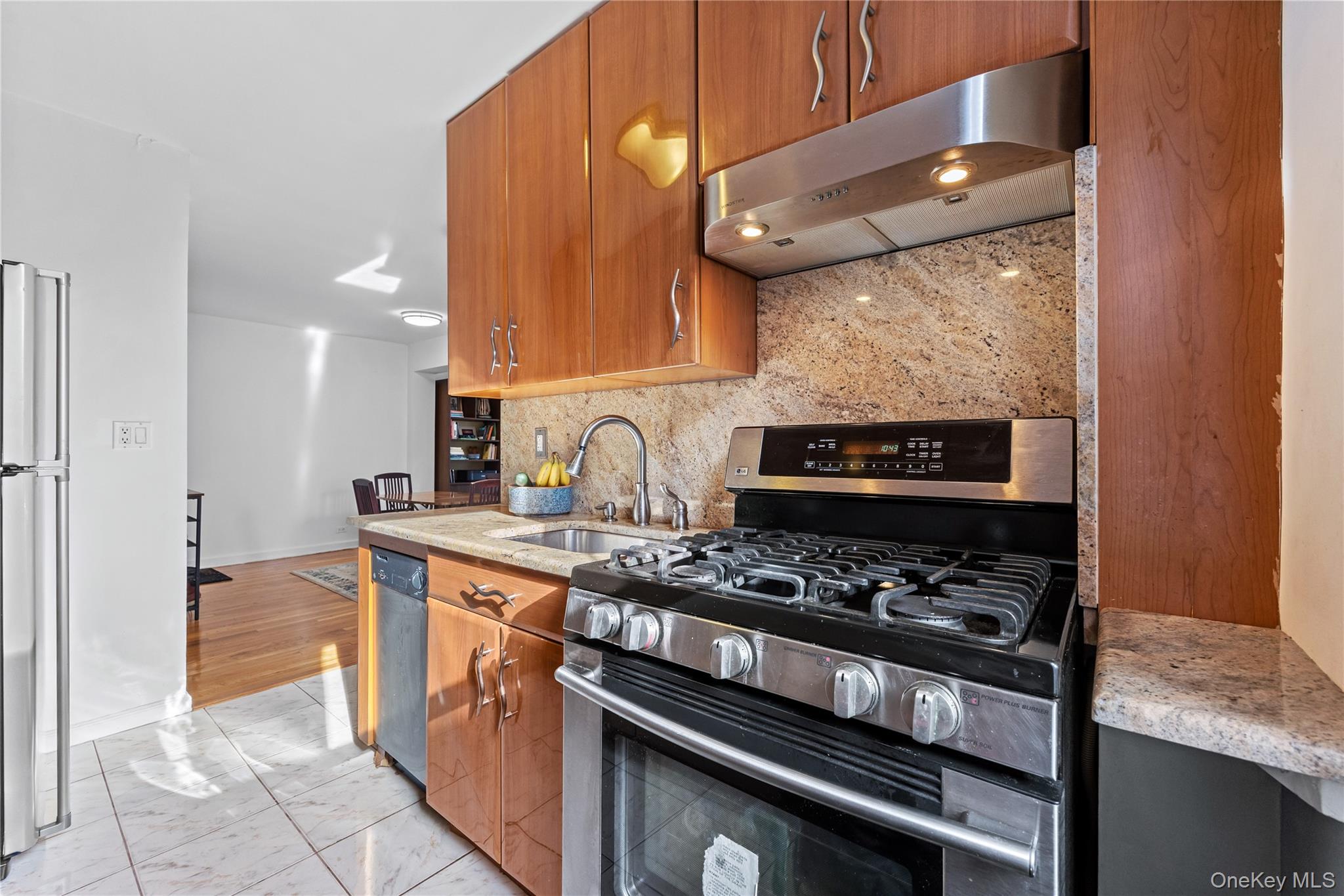 325 East 201st Street, Unit 5F Bronx, NY 10458 - Photo 8 of 19 a kitchen with stainless steel appliances granite countertop a stove and a microwave