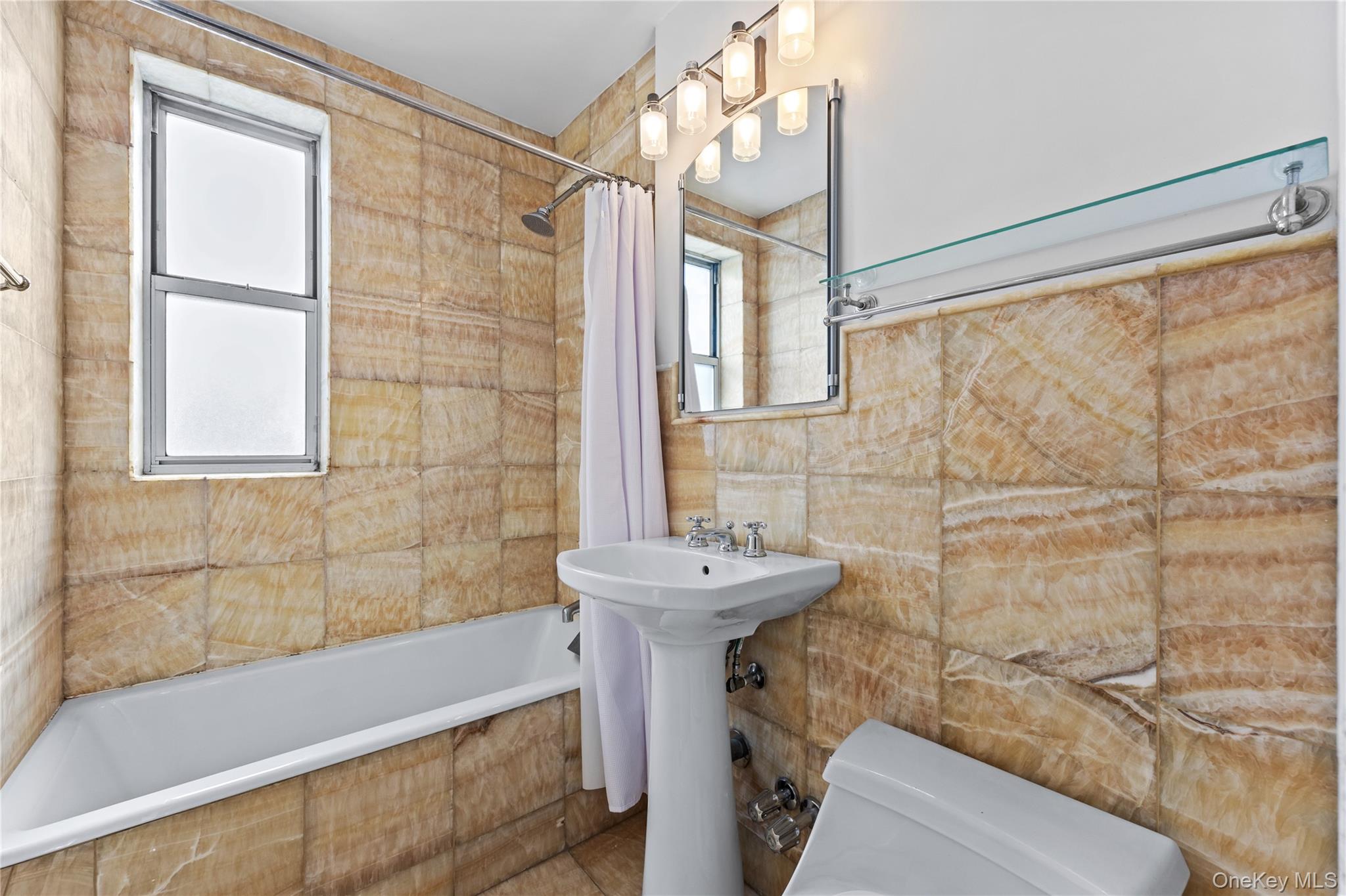 325 East 201st Street, Unit 5F Bronx, NY 10458 - Photo 9 of 19 a bathroom with a sink a bathtub and shower