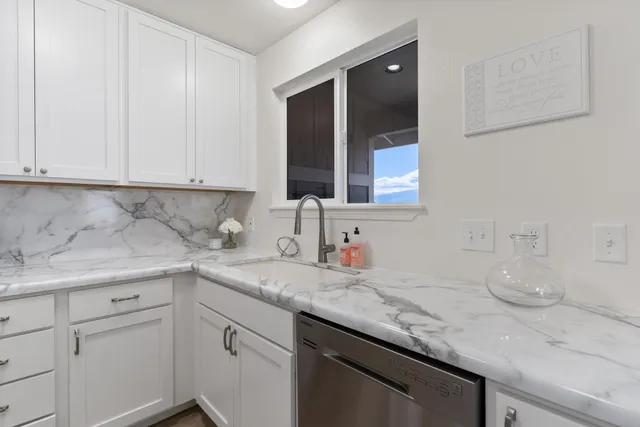 a kitchen with a sink stove and microwave