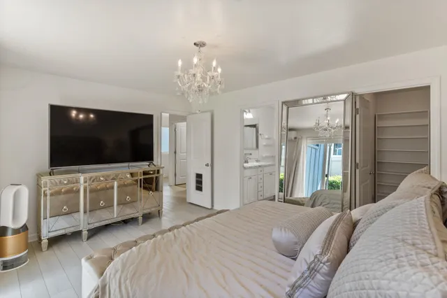 a bedroom with furniture and a flat screen tv