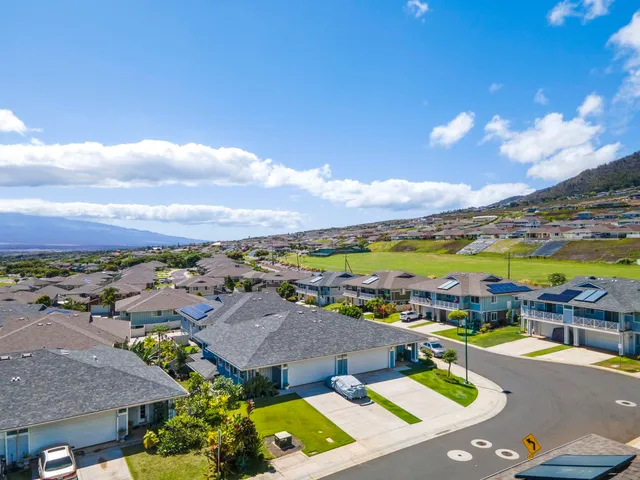 an aerial view of a houses with a swimming pool