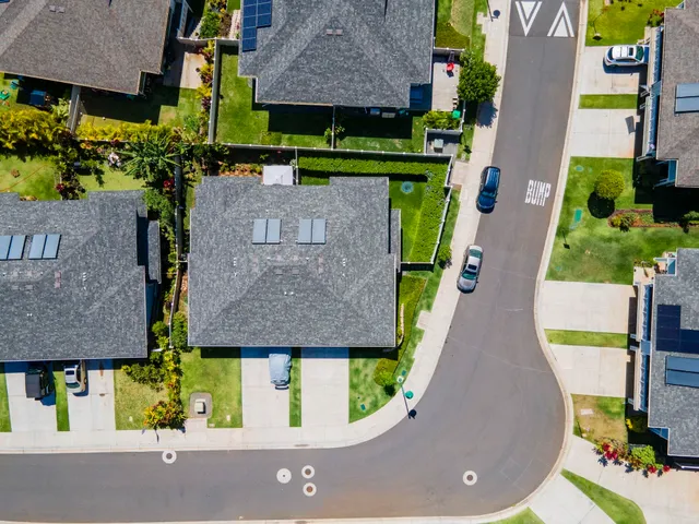 a living room with furniture kitchen view and a wooden floor