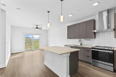 a kitchen with a sink stove and cabinets