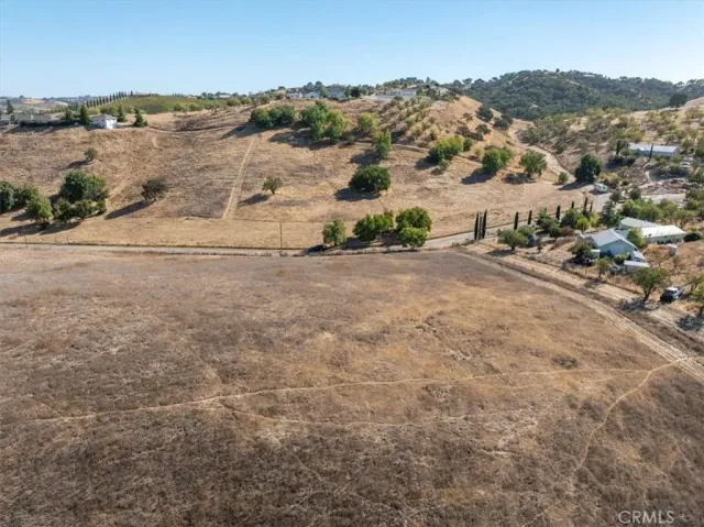 an aerial view of ocean with residential house and outdoor space