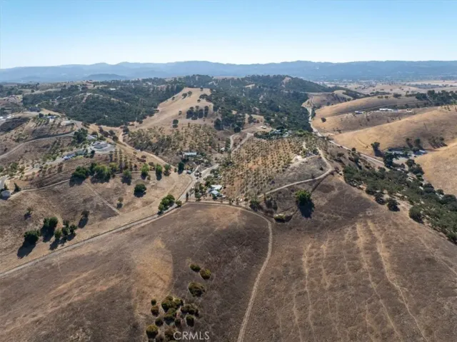 an aerial view of a house with a mountain
