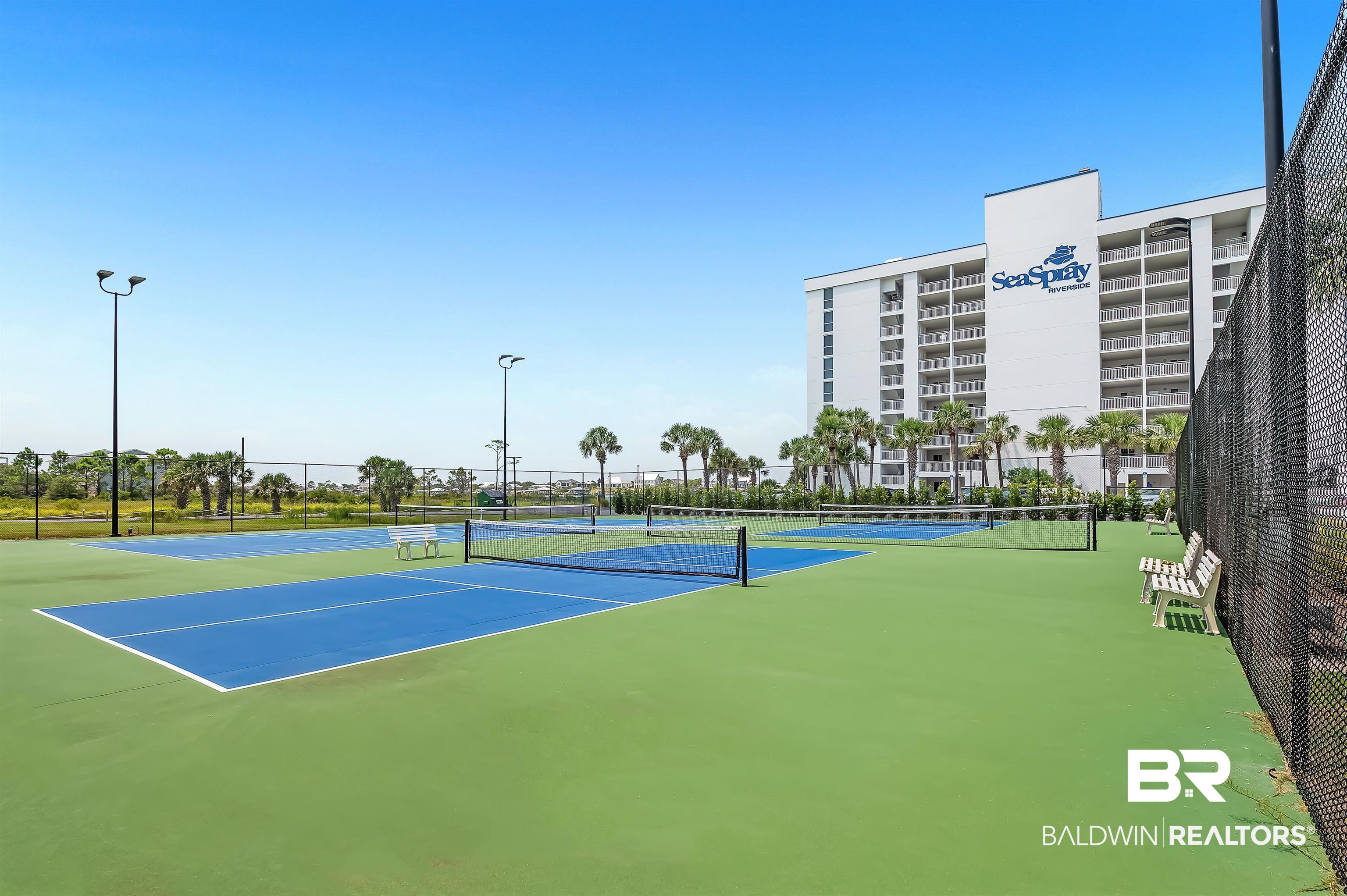16287 Perdido Key Drive, Unit 105 Pensacola, FL 32507 - Photo 46 of 66 Multiple outdoor courts featuring blue playing surfaces and green surrounds