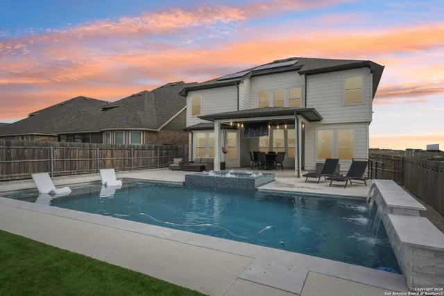 a view of a house with pool table and chairs