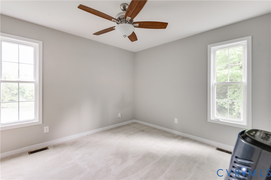 24580 St James Road Jetersville, VA 23083 - Photo 2 of 25 Carpeted room with light grey walls, two windows,