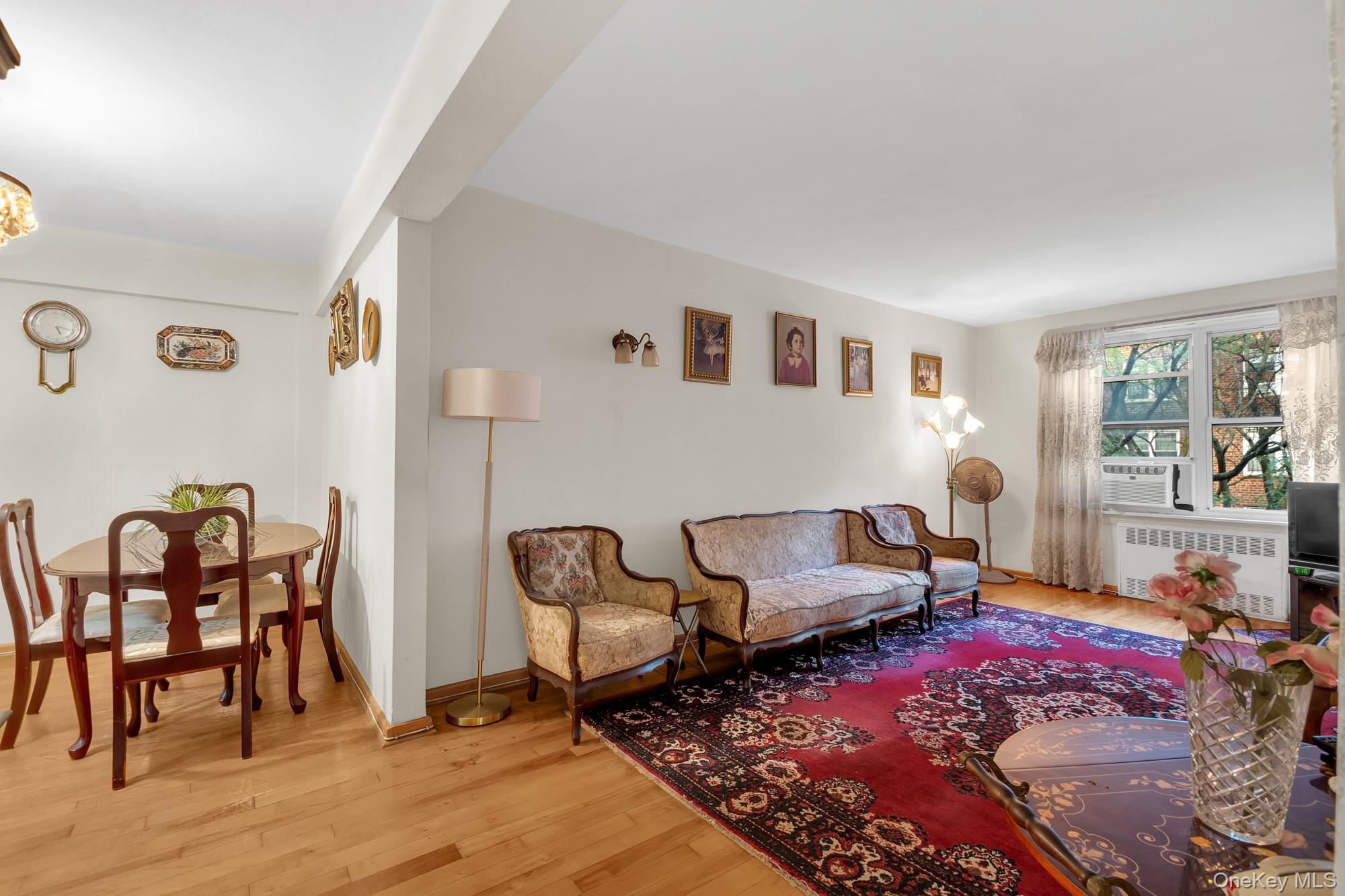 33-26 82nd Street, Unit 4C Queens, NY 11372 - Photo 1 of 10 a living room with furniture and wooden floor