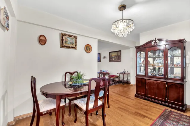 a view of a dining room with furniture a chandelier and wooden floor