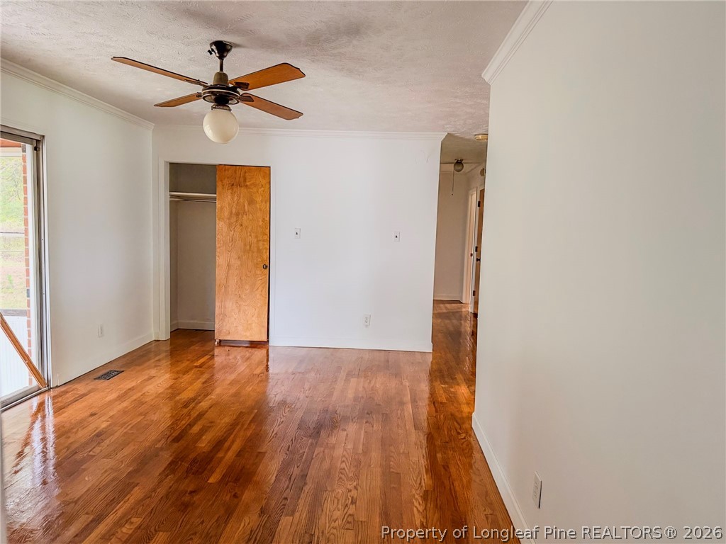 598 Forest Road Lumberton, NC 28358 - Photo 5 of 25 a view of empty room with wooden floor and fan