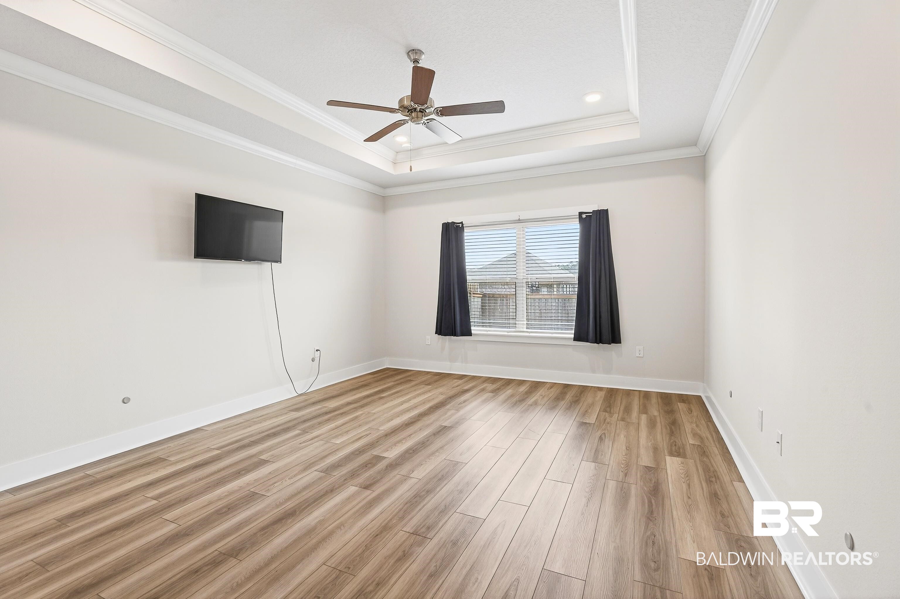 1728 Partridge Street Foley, AL 36535 - Photo 18 of 37 Spare room with light wood-style floors, a ceiling fan, and ornamental molding